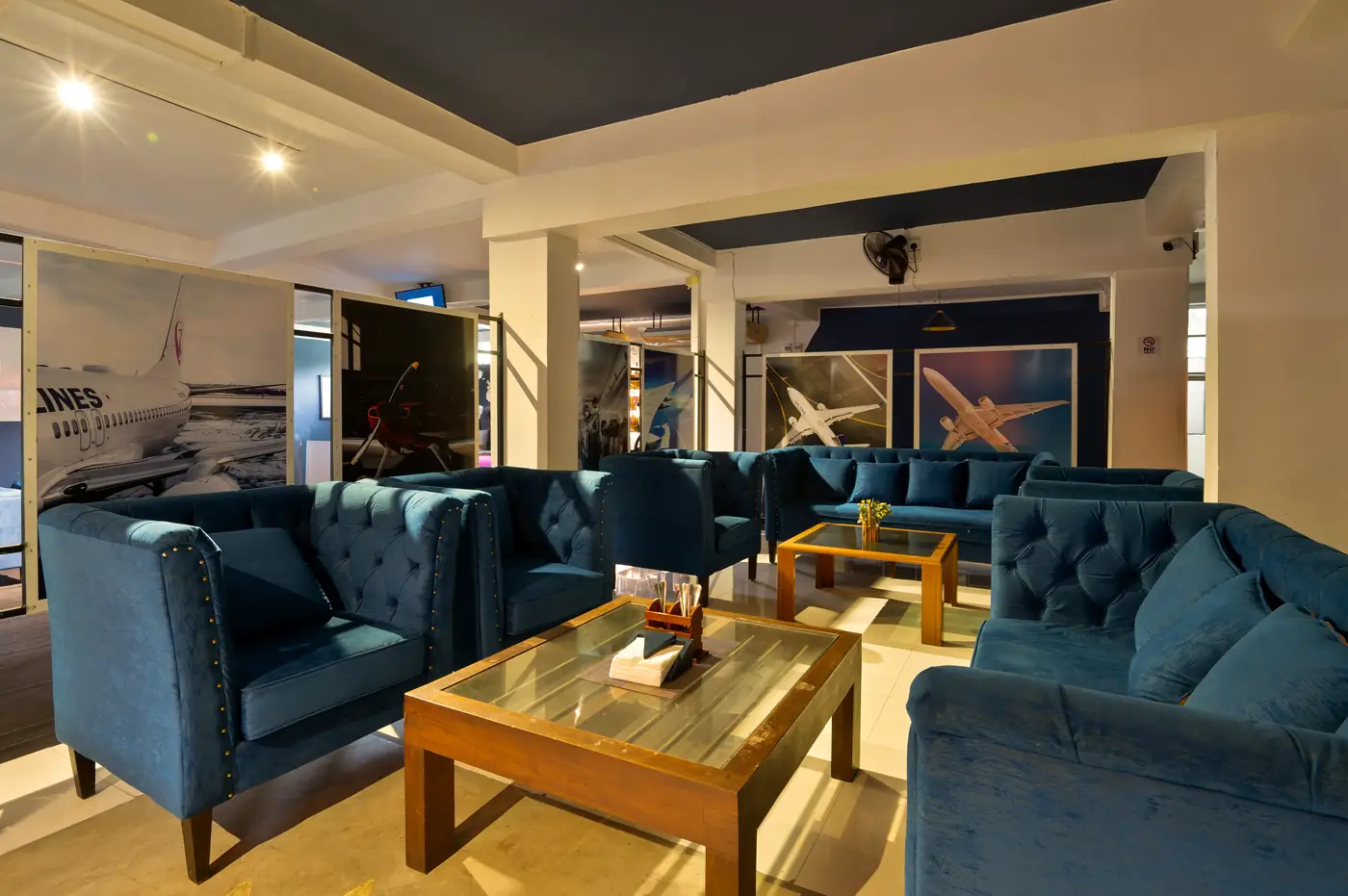 The Flight Deck Bar lounge with navy chesterfield sofas and aviation art